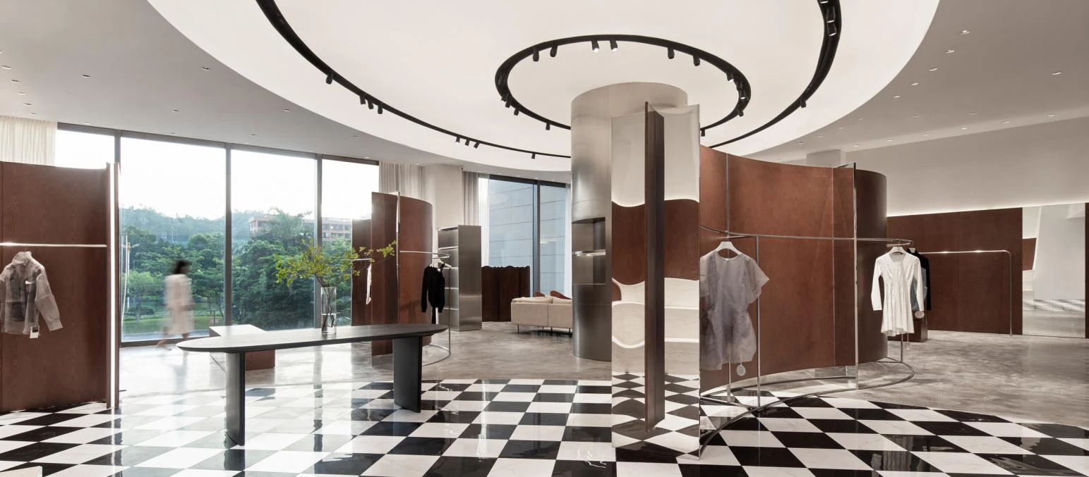 LWQ boutique retail interior with curved metal displays and a black-and-white floor